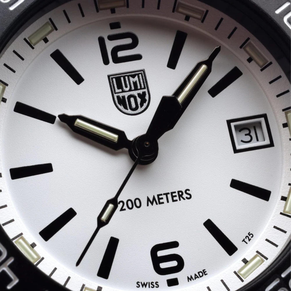 Close-up of the white watch face, black indices, date window, and logo on the Luminox Pacific Diver XS.3127M