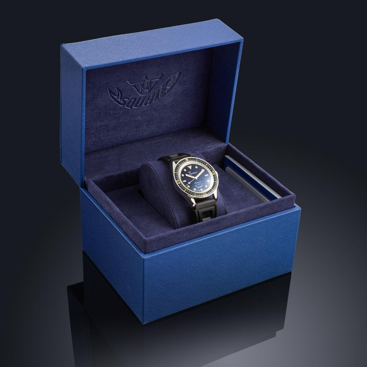 Men's black dial dive watch in a blue presentation box with black rubber strap