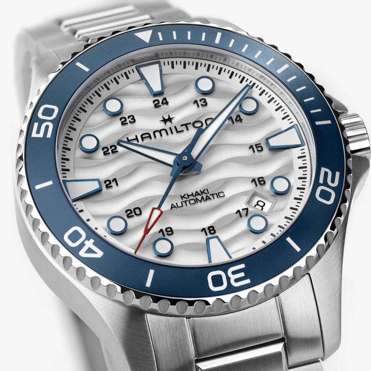 Close-up detail of Hamilton Khaki Navy Scuba H82425110 displaying blue hour markers, luminescent hands, and patterned dial face