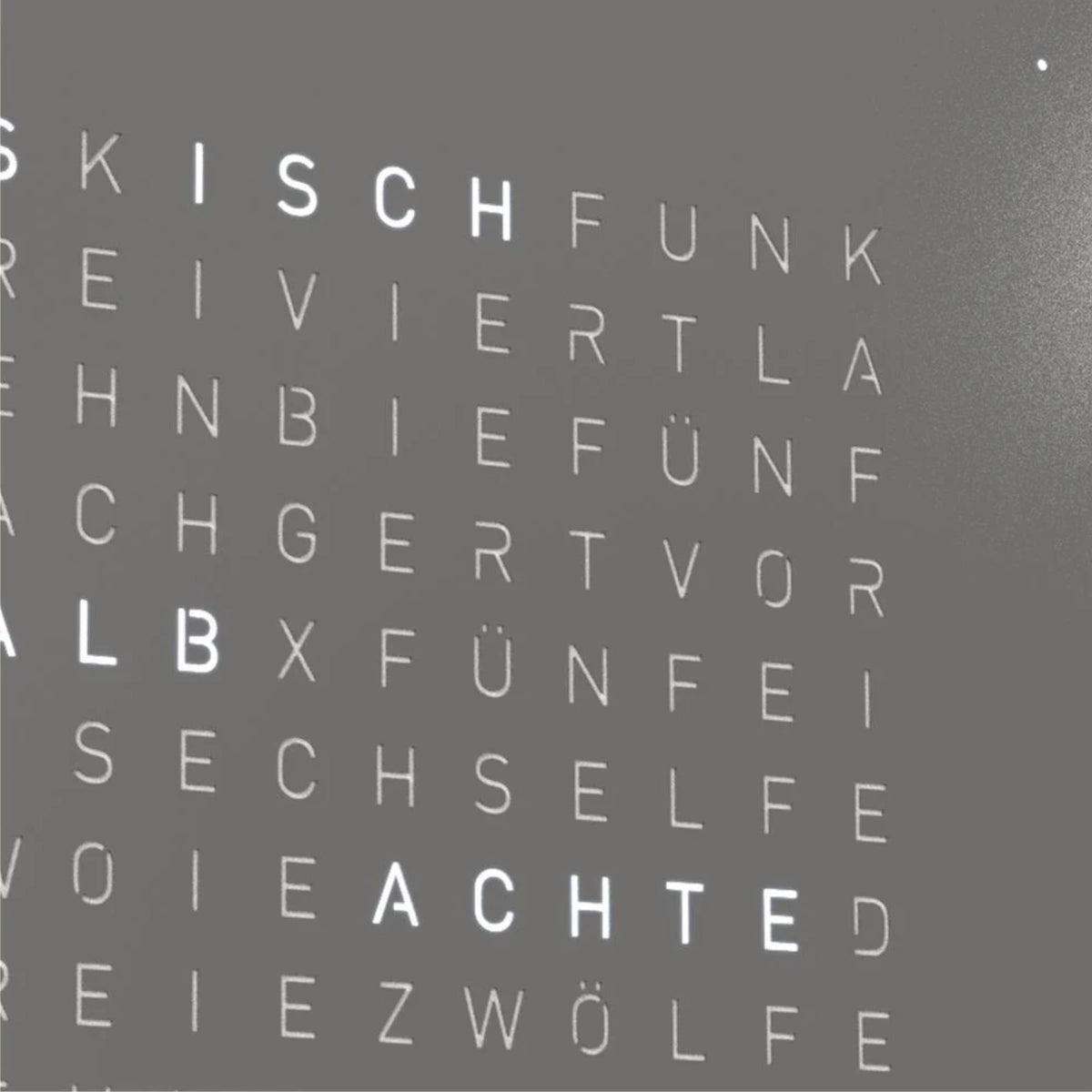 Close-up of grey QLOCKTWO Earth 45 word clock face with English letter layout
