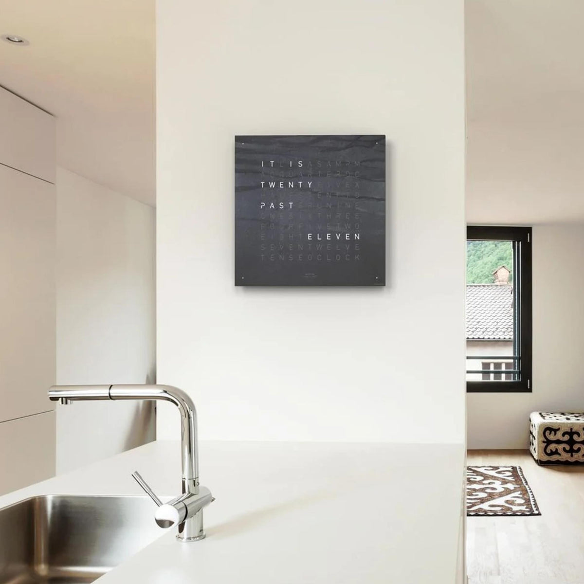Square wall clock mounted on a wall with dark slate face and word time text
