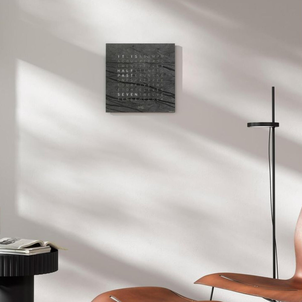 Square wall clock with dark slate face showing layered word time lines