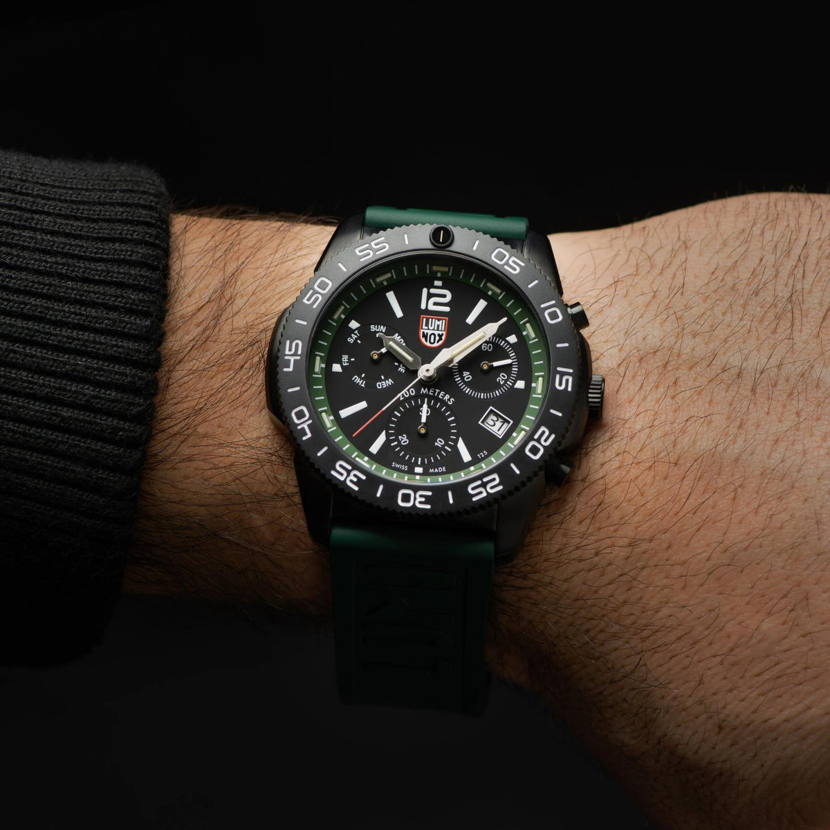 Men's diver chronograph quartz watch on wrist, black dial with green accents, rubber strap