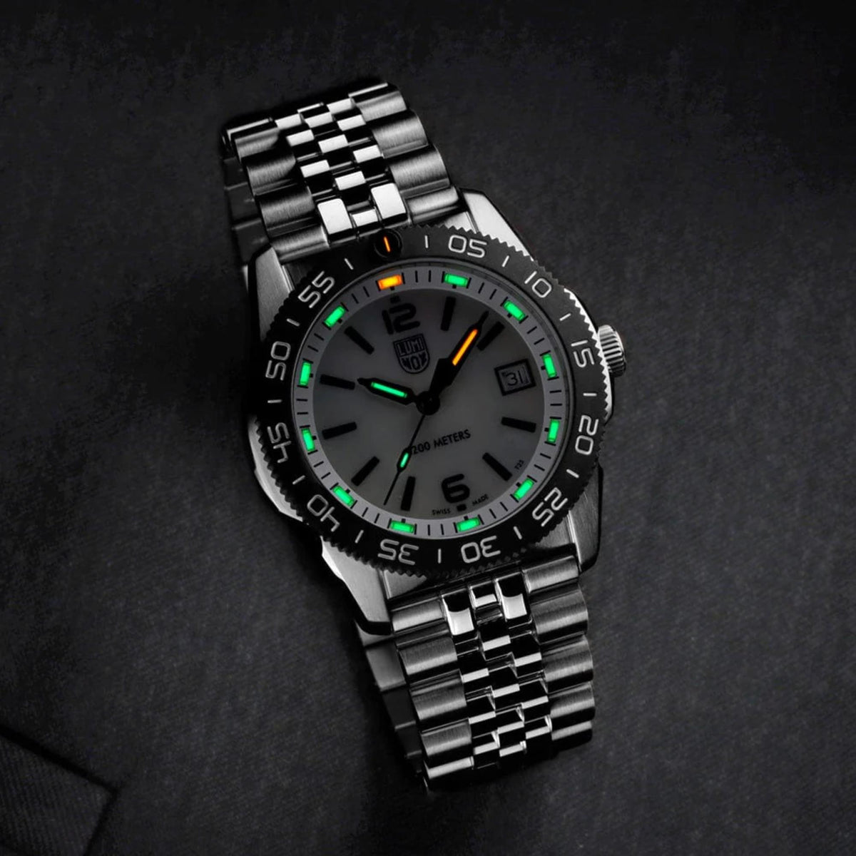 Black dial diver watch with black bezel, luminous markers, date window, metal bracelet