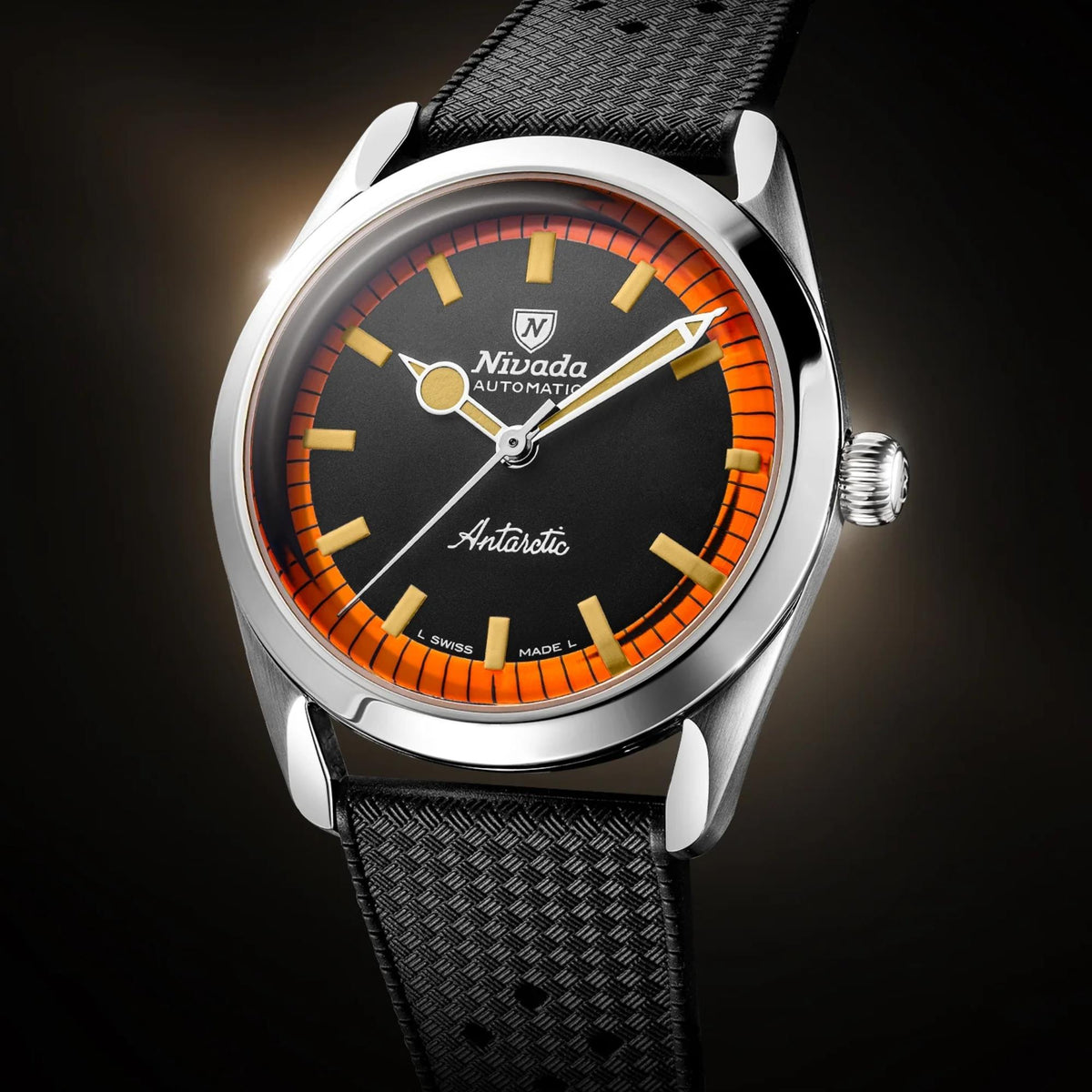 Men's automatic wrist watch dial closeup, black with orange indices and textured strap