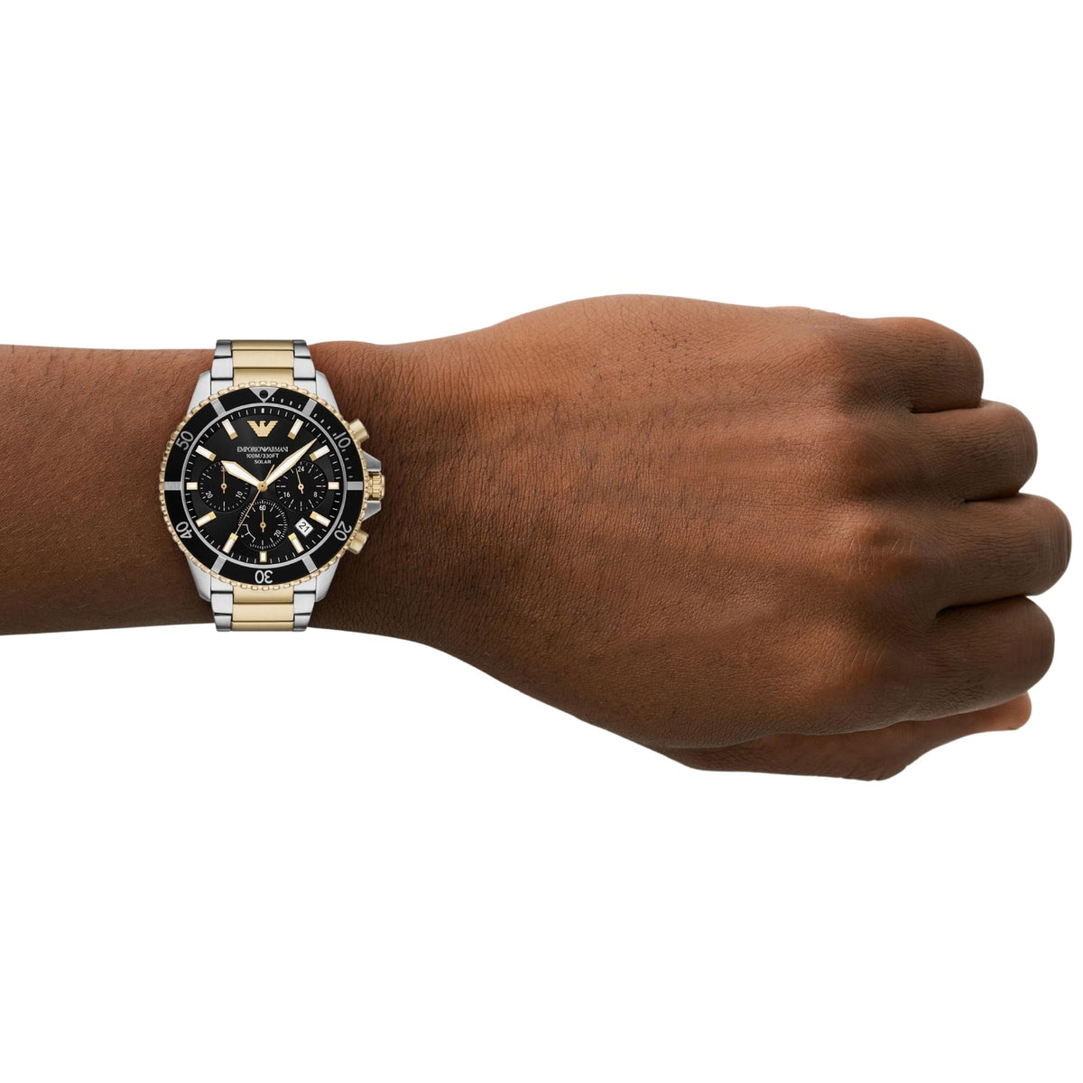 On-wrist perspective of the Emporio Armani World Explorer AR11680 timepiece highlighting the 43.5mm case, black bezel, and gold-tone pushers