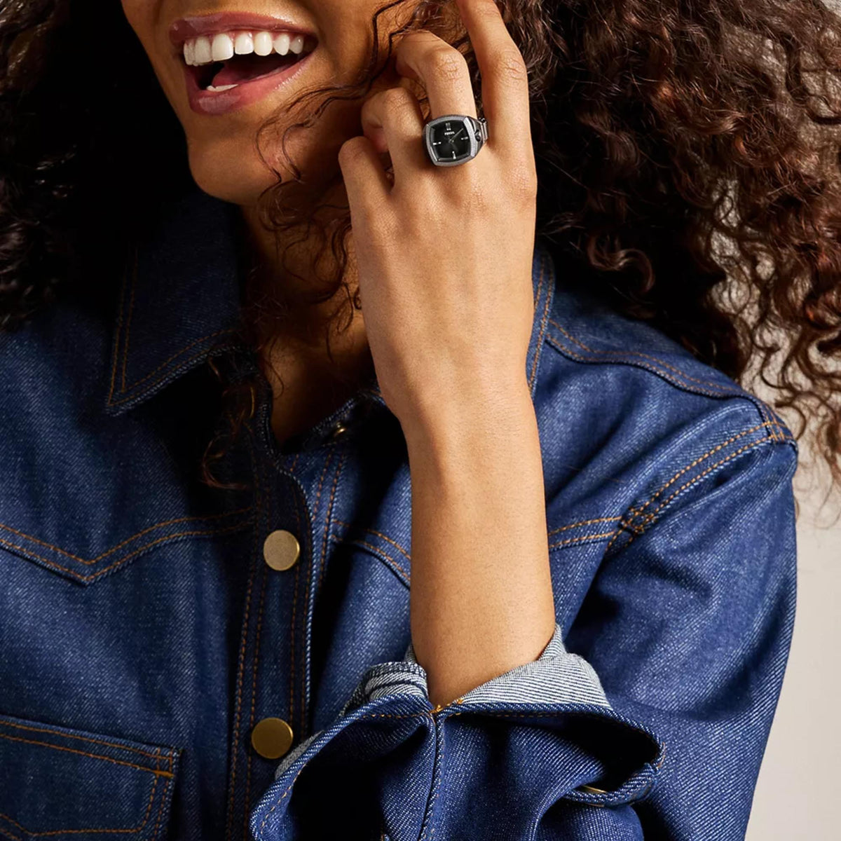 On-finger model shot of the Fossil Machine x Nick Jonas LE1212 watch ring displayed against a dark denim jacket