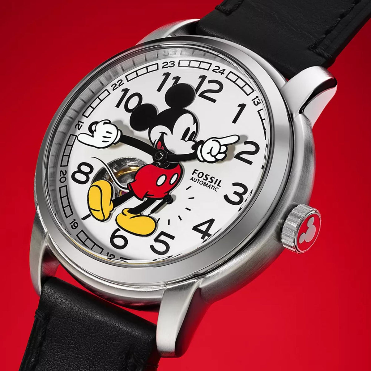 Angled close-up of the Fossil Disney Mickey Mouse SE1111 white dial with animated hands and red accent crown