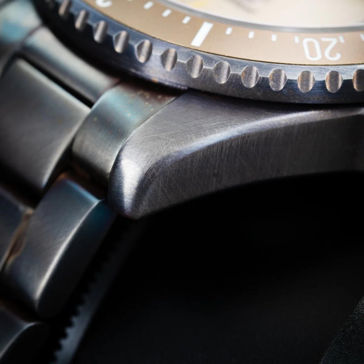 Men's automatic wristwatch macro view of steel case and bracelet link detail