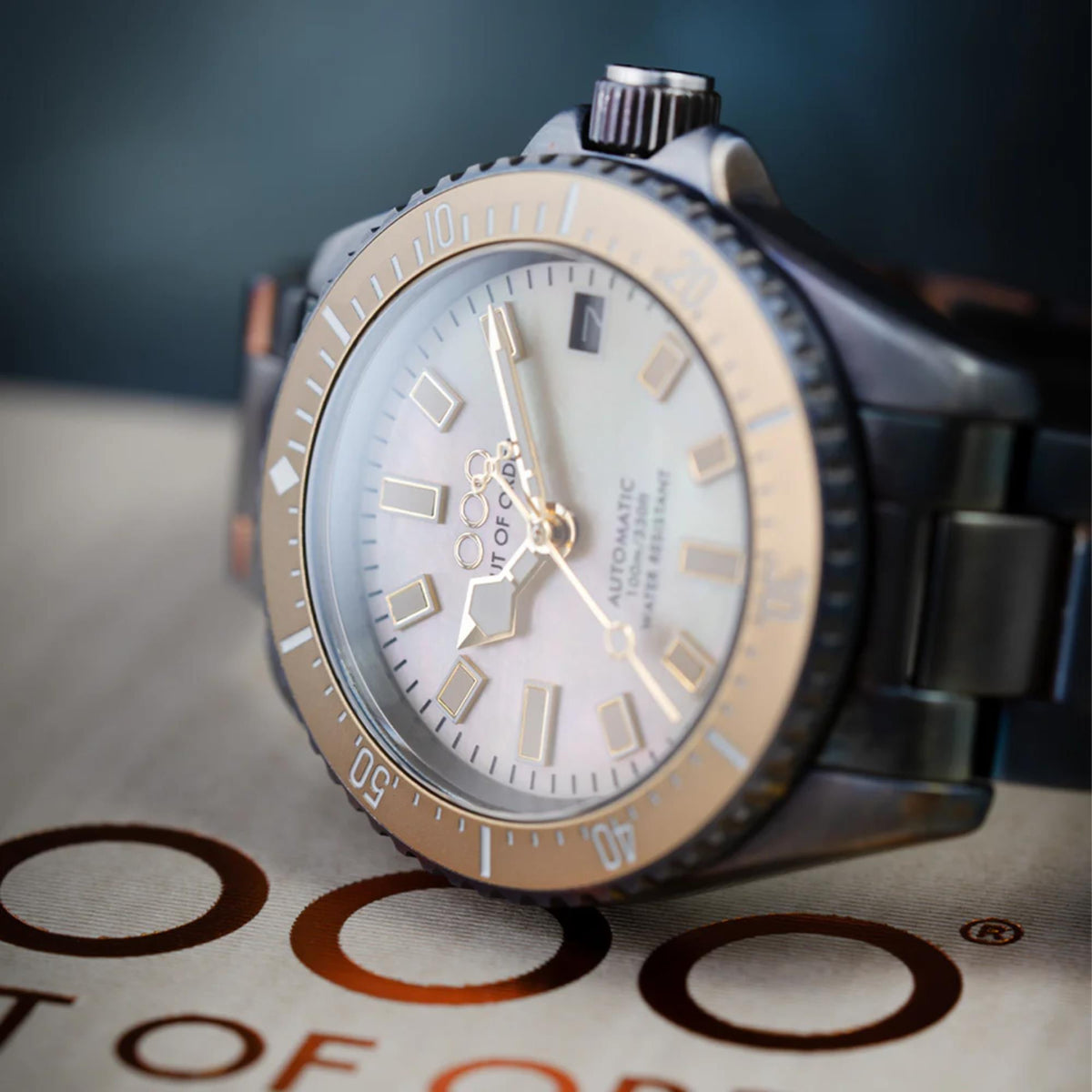 Men's automatic wristwatch angled view with ivory dial and steel bracelet