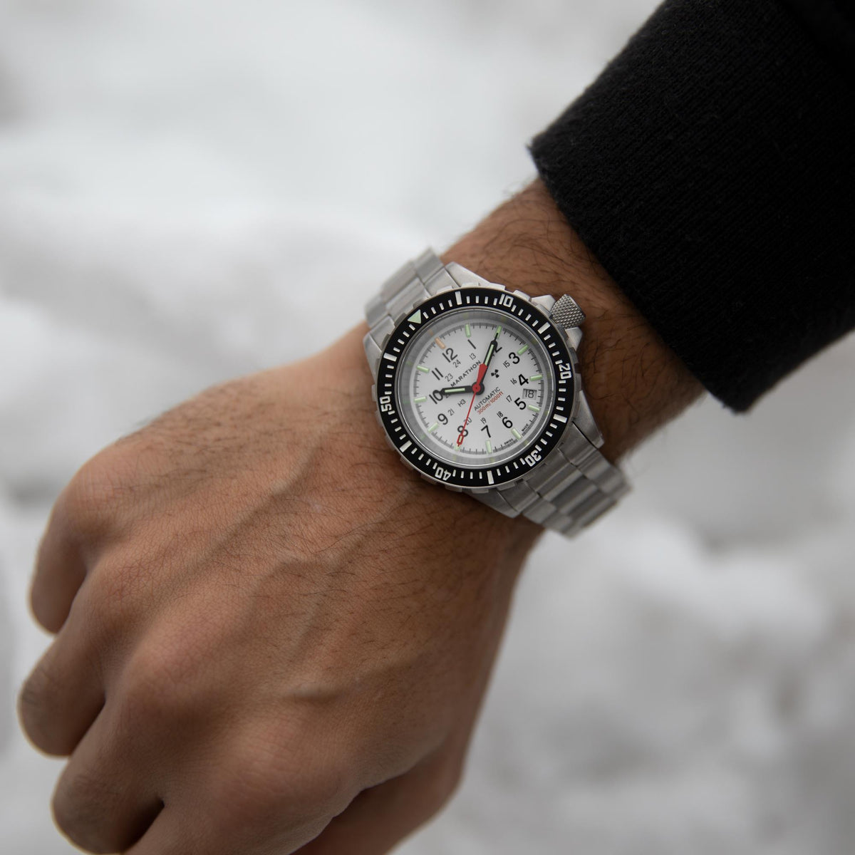 Marathon GSAR Arctic Edition WW194006SS-0513 mens automatic wrist watch worn outdoors against a snowy backdrop