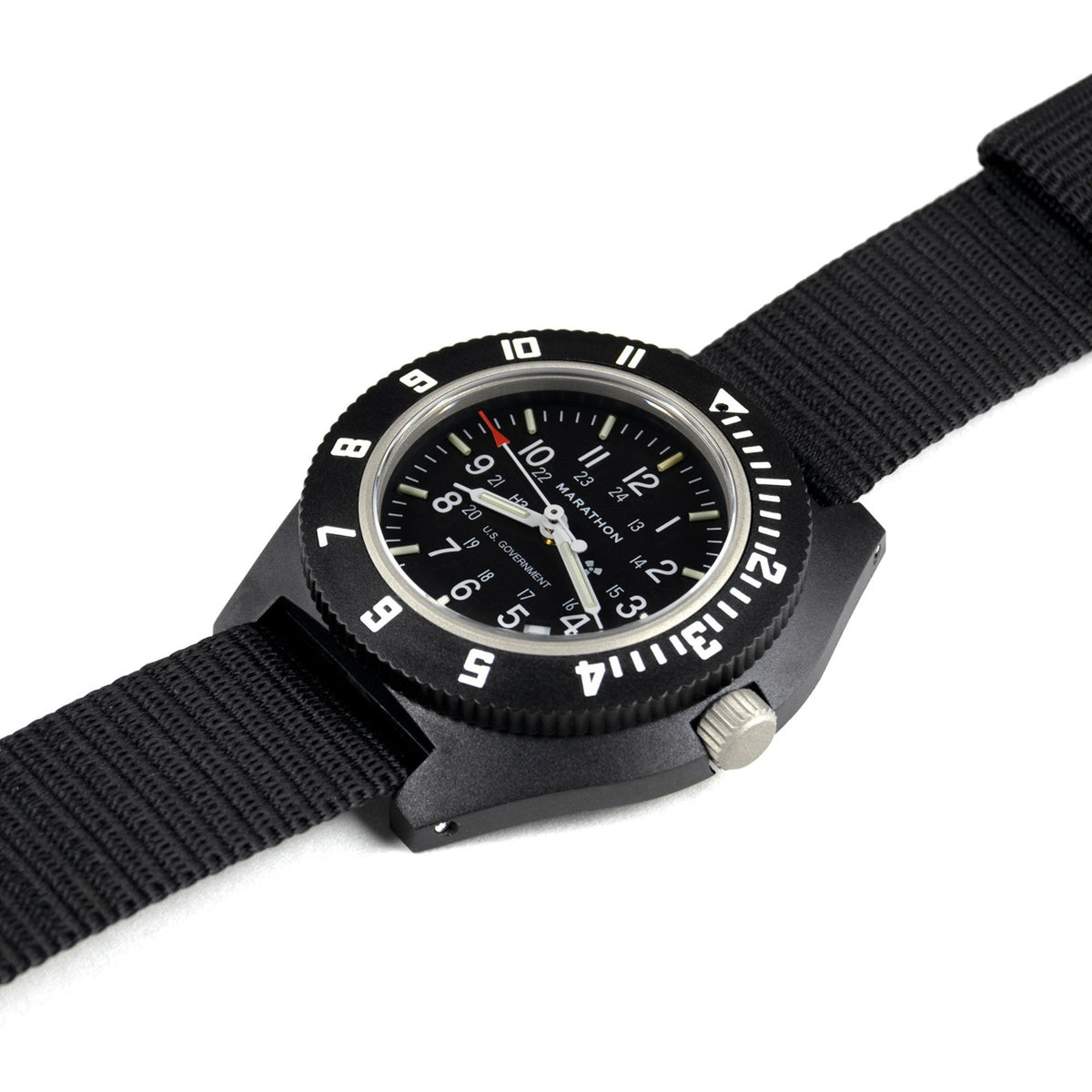 Marathon Navigator WW194013BK-0001 men's quartz watch laid flat on a white surface, displaying a black nylon strap and bezel
