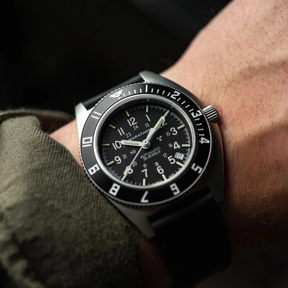 Marathon Navigator SSNAV-D WW194030SS-0130 automatic watch shown on wrist, displaying stainless steel case and black dial