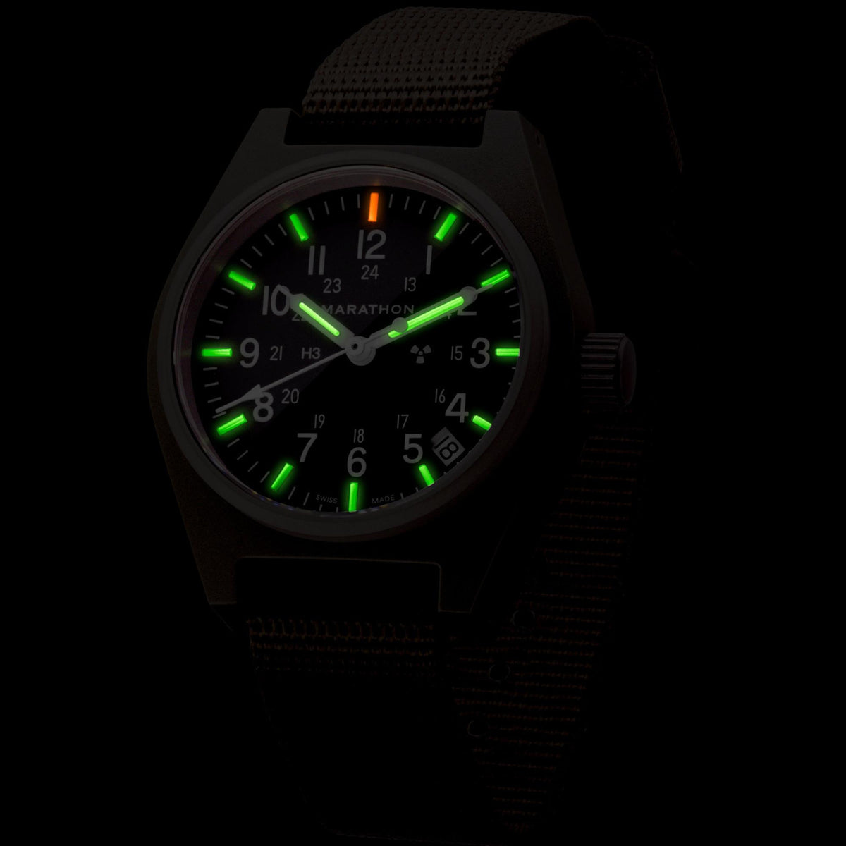 Marathon General Purpose Field WW194015SG-0103 quartz watch displaying glowing tritium gas tubes on dial in dark conditions