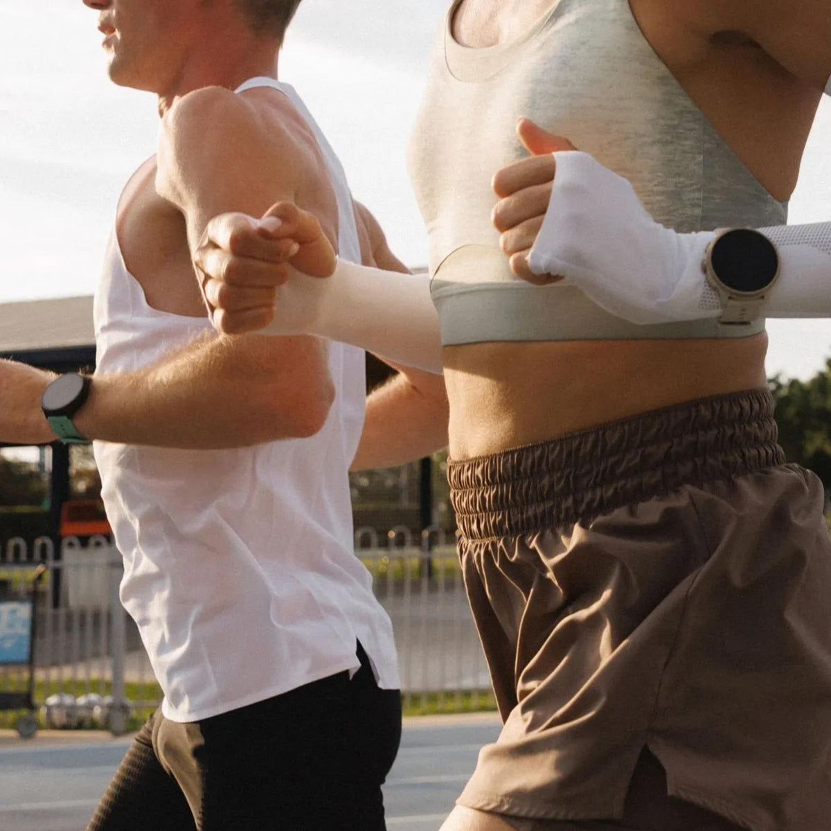 Suunto Run SS051725000 side view showing digital screen and strap buckle fastening on a couple's wrist