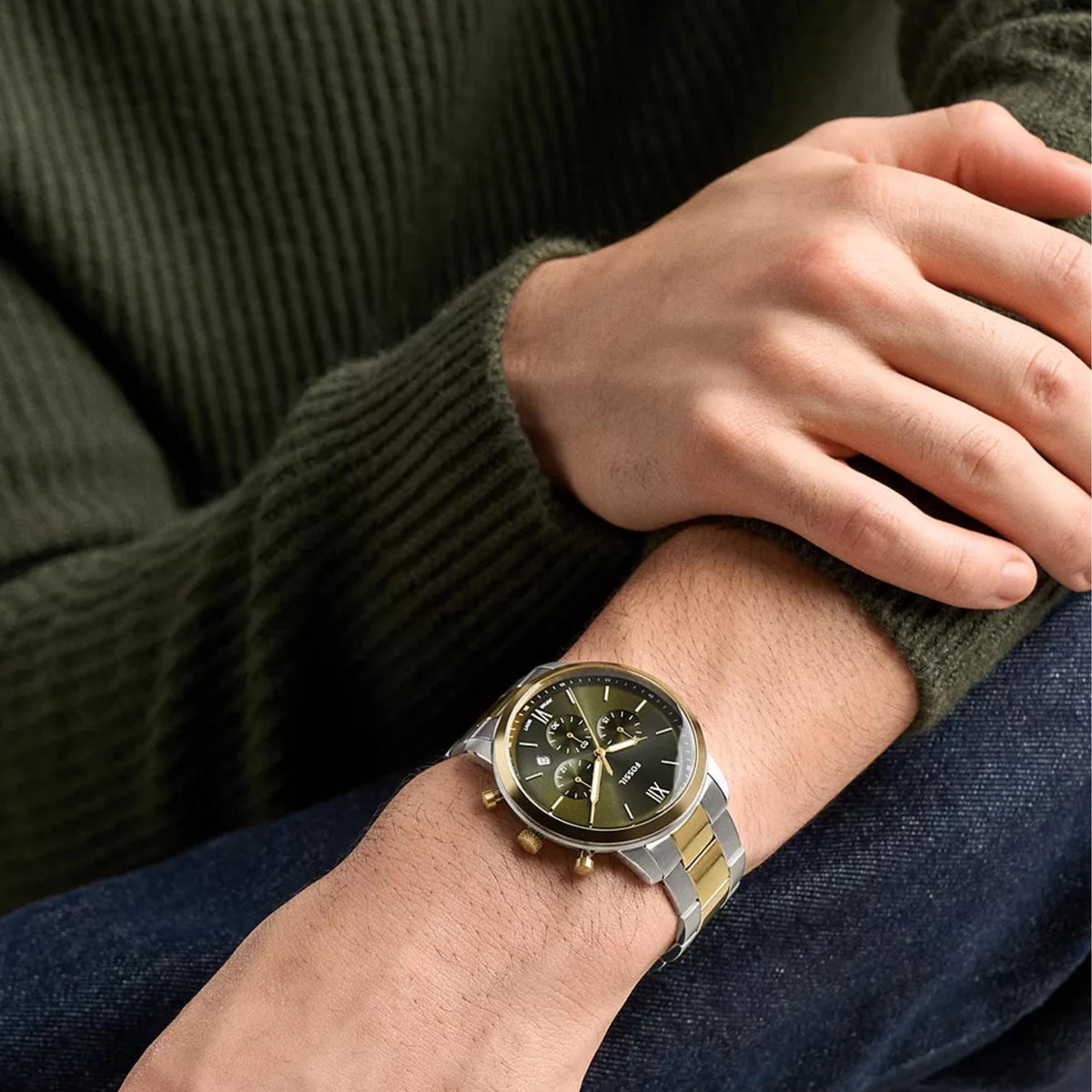 On-wrist view of the Fossil Neutra FS6189 quartz timepiece highlighting the green chronograph dial and silver and gold-tone bracelet
