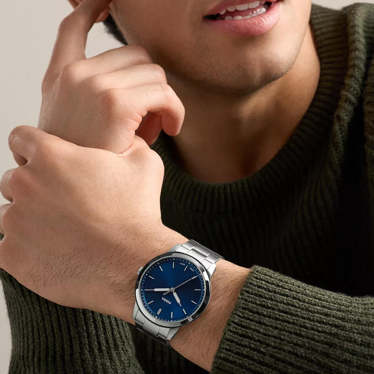 Fossil Minimalist FS6180 mens quartz watch on wrist featuring round blue dial and silver tone steel case
