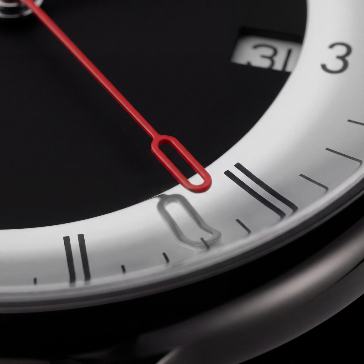 Mondaine Doppio Mirror MLE.41280.SM macro view of dial perimeter showing second hand, index tracking, and date display
