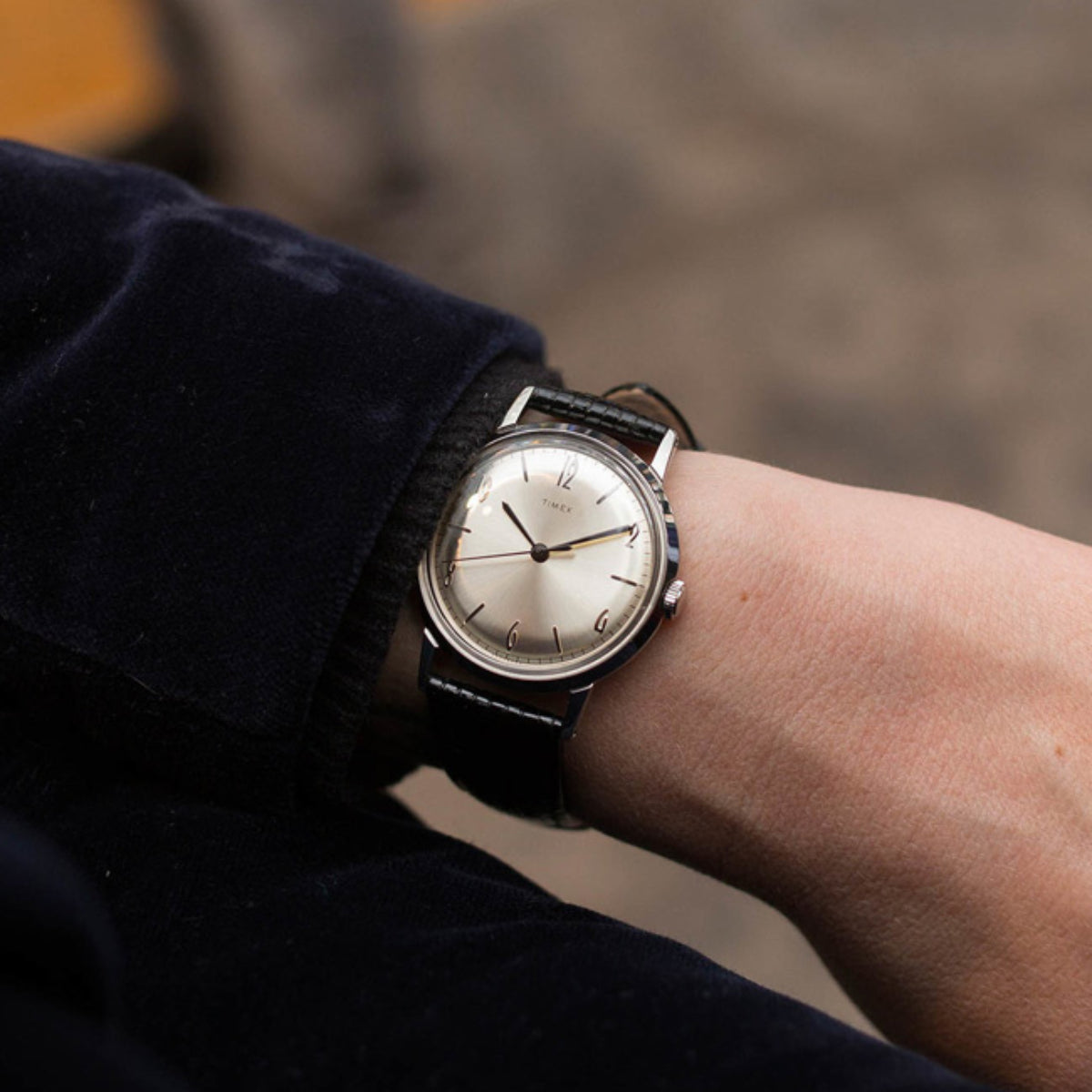 Timex Marlin automatic watch on wrist with black leather strap and light dial
