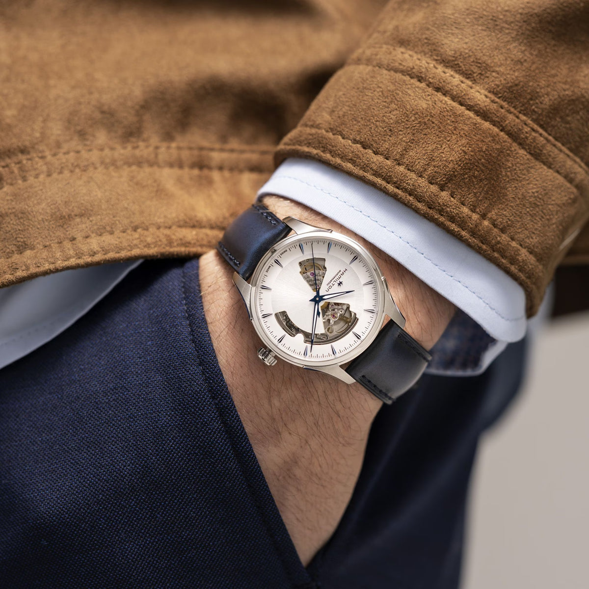 Men's open-heart automatic watch with silver case, white dial, blue hands, leather strap