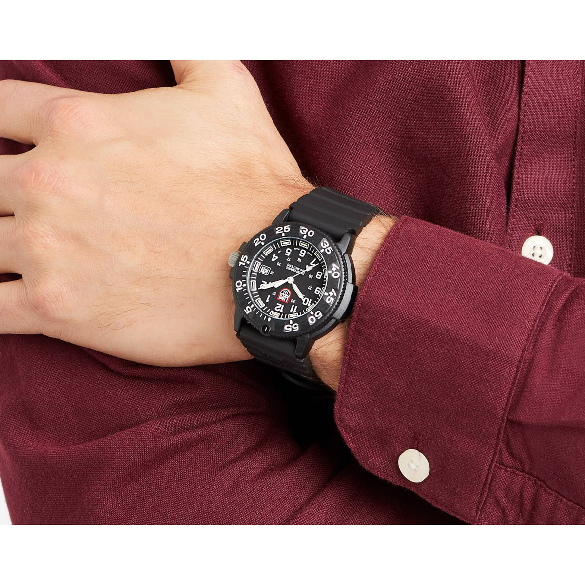 Luminox Navy Seal black dial rubber quartz watch worn on wrist with round black bezel