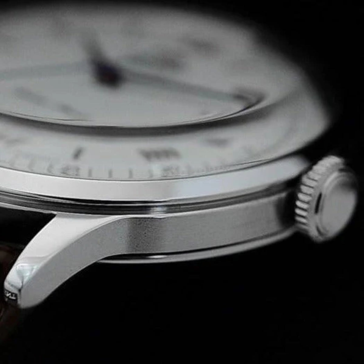 Orient Bambino TAC00009W0 wrist watch held up outdoors, displaying the white dial and blue hands in natural light