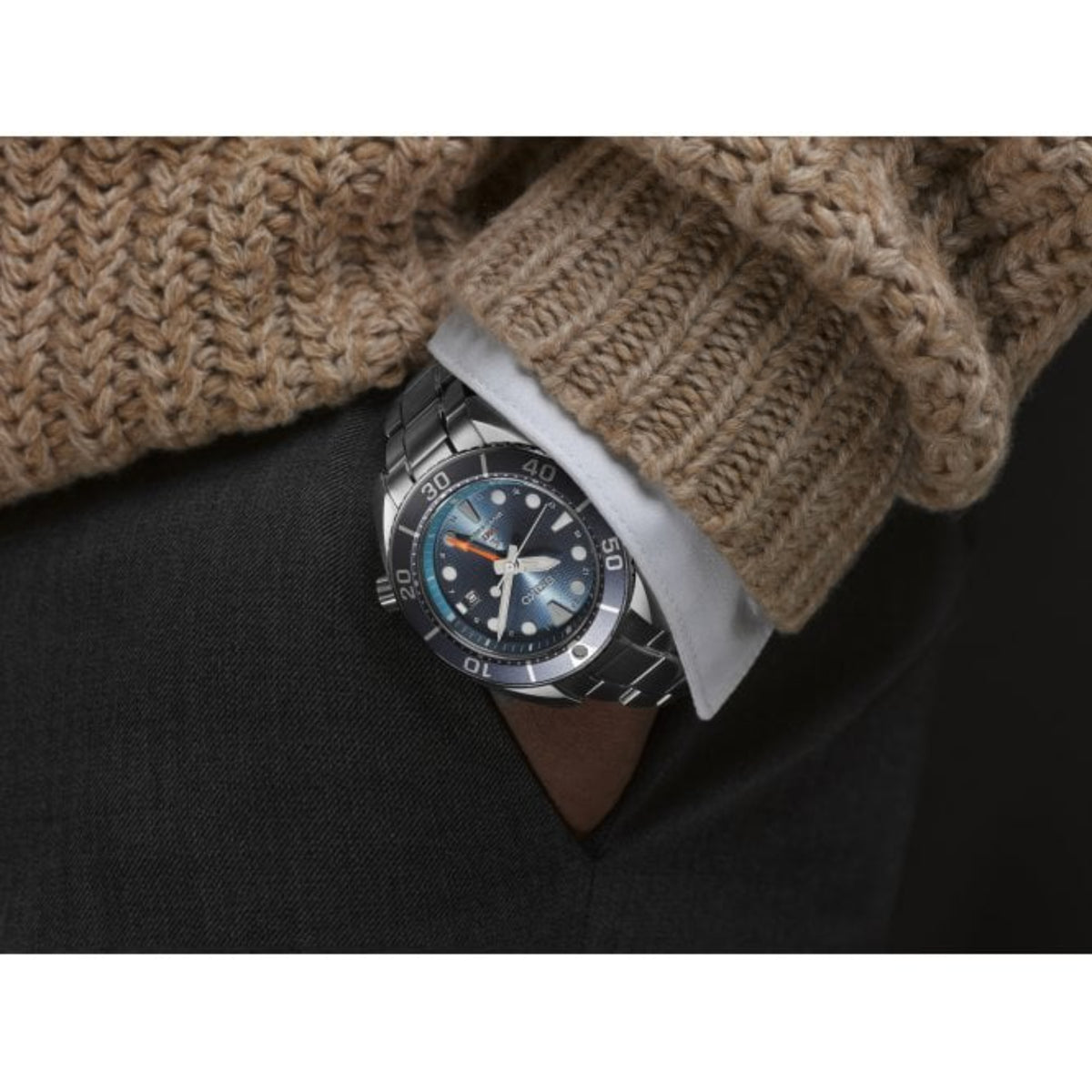 Close-up Seiko Prospex SFK001J1 watch on wrist with a textured sleeve and dark fabric background
