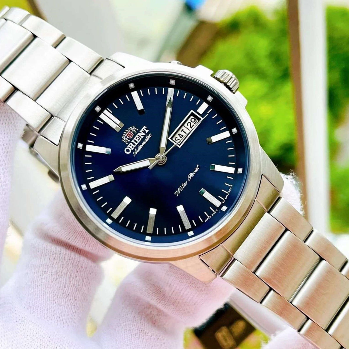 Orient Contemporary RA-AA0C02L39B wristwatch with blue dial on a blurred background