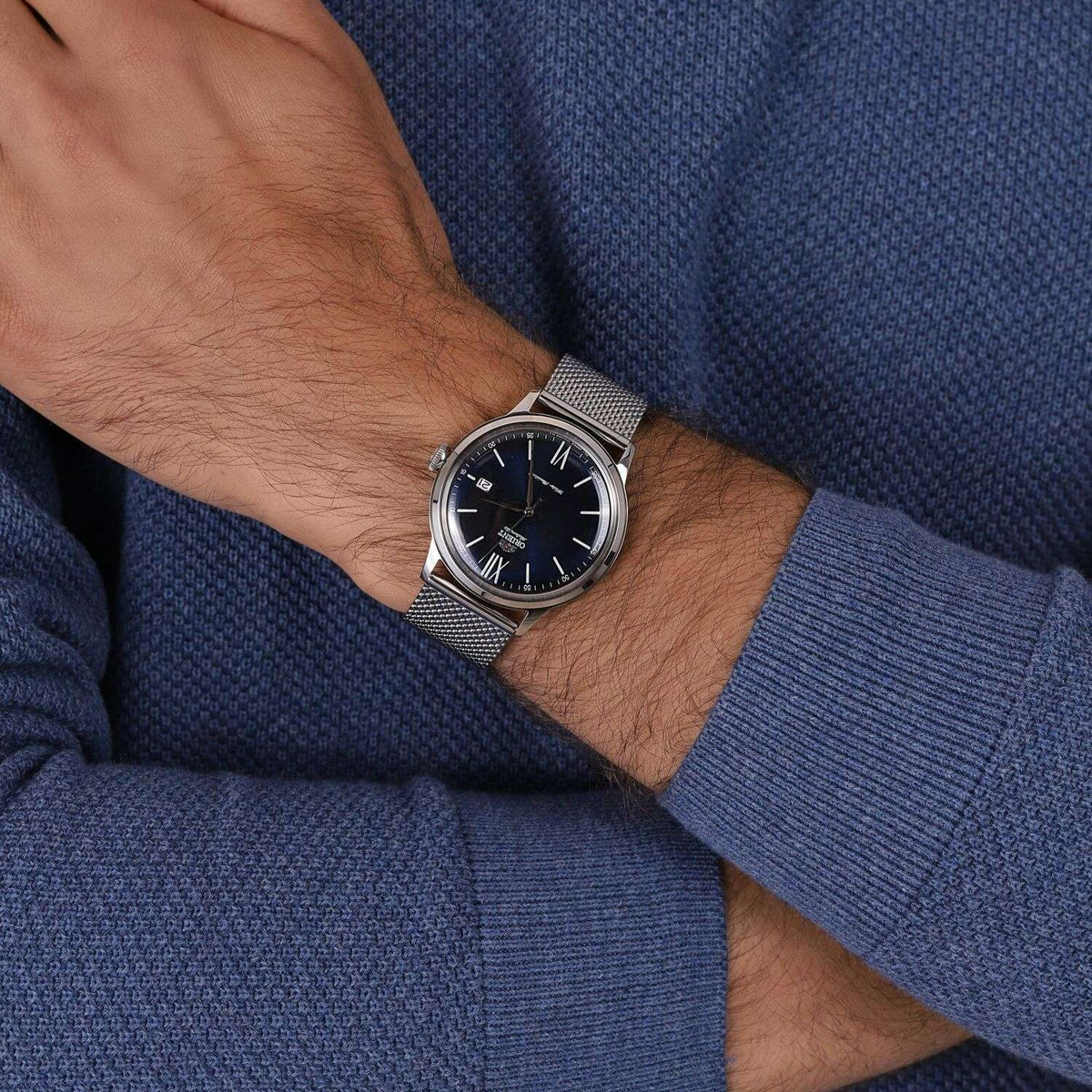 Men's steel automatic wristwatch with blue dial, Roman numerals, and bracelet