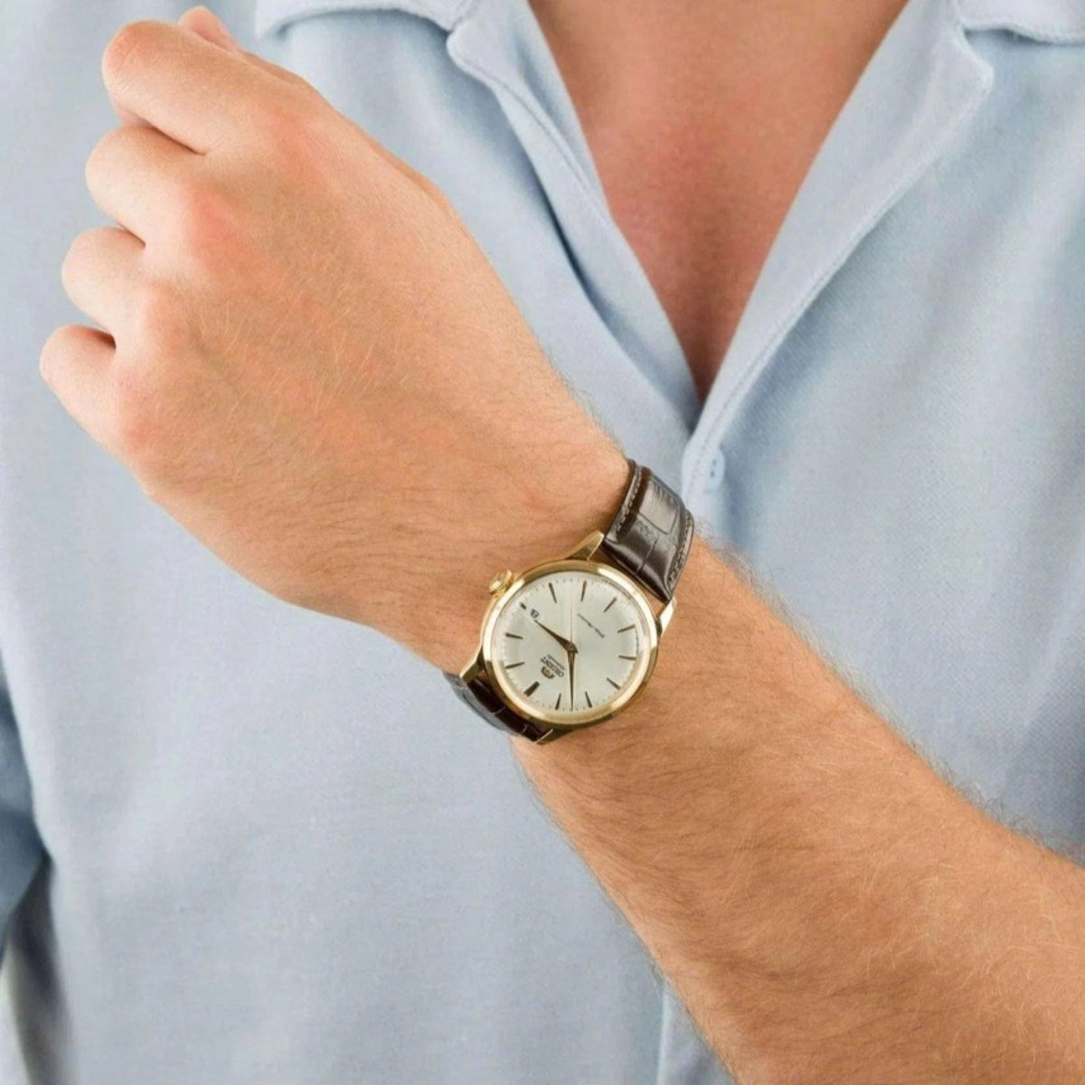 Mens automatic wristwatch with white dial and dark leather strap, round gold-tone case