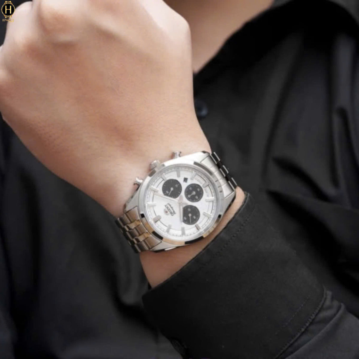 Men's solar chronograph watch on wrist, white dial with three black subdials