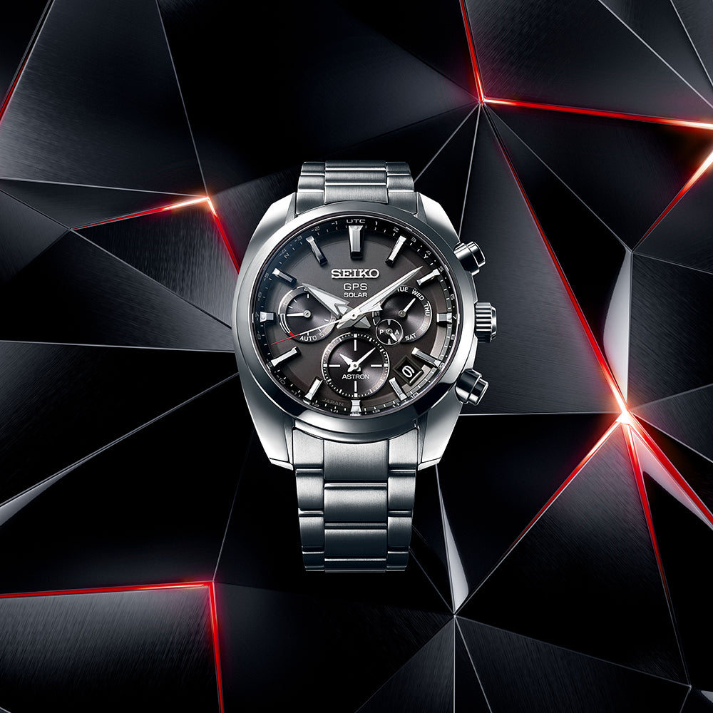Men's Seiko GPS Solar watch front view, black dial with subdials, steel bracelet