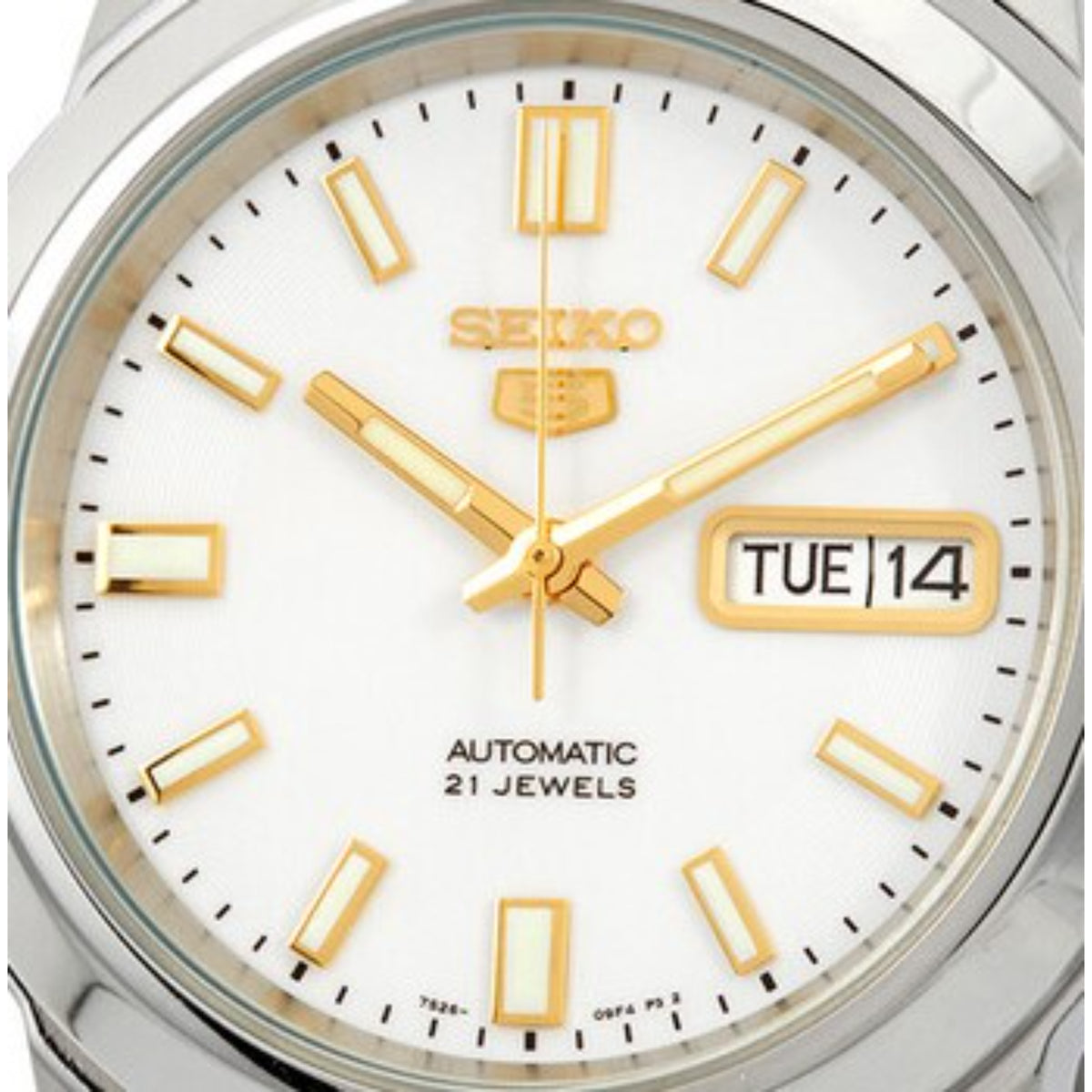 Seiko 5 dial close-up, white face, gold hour markers, TUE 14 date window