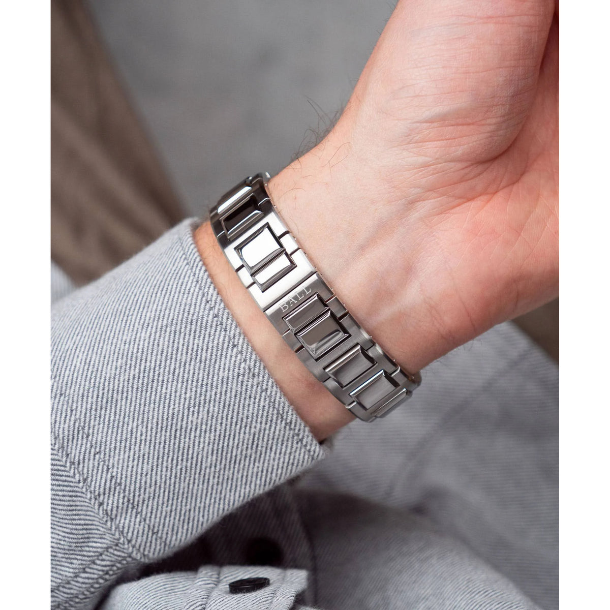 BALL Engineer III Marvelight NM9026C-S46C-MSLR wrist view highlighting steel bracelet clasp and mens sleeve cuff