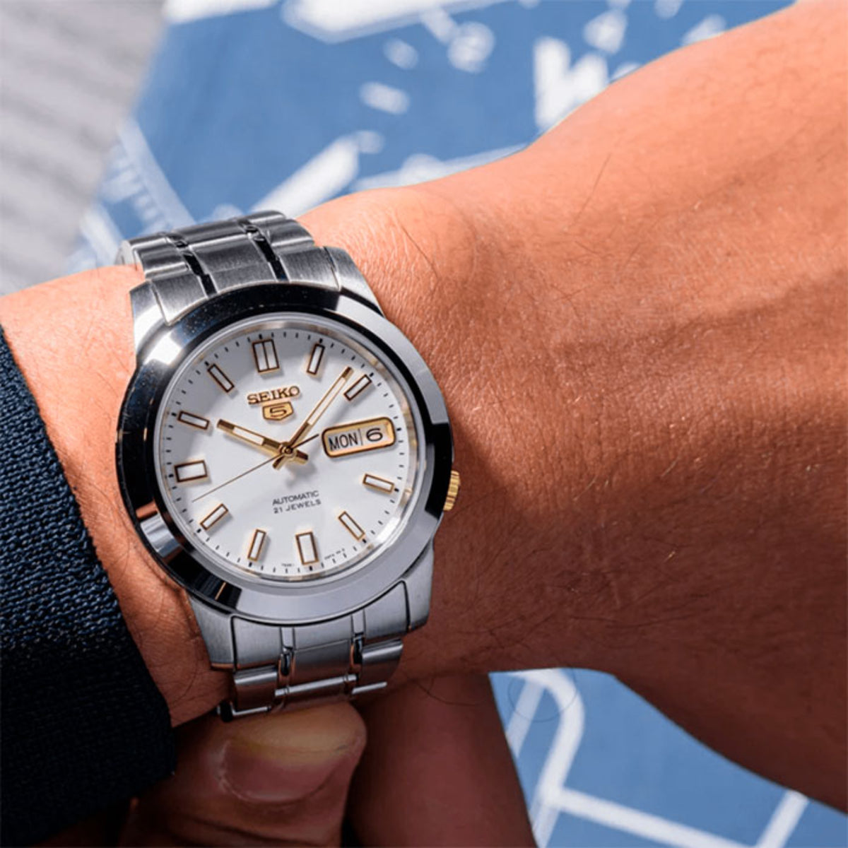 Seiko 5 automatic watch on wrist, white dial with gold markers and MON 6 date