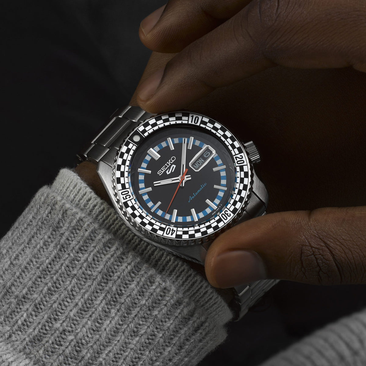 Seiko 5 Sports SRPK67K1 lifestyle wrist shot with grey sweater