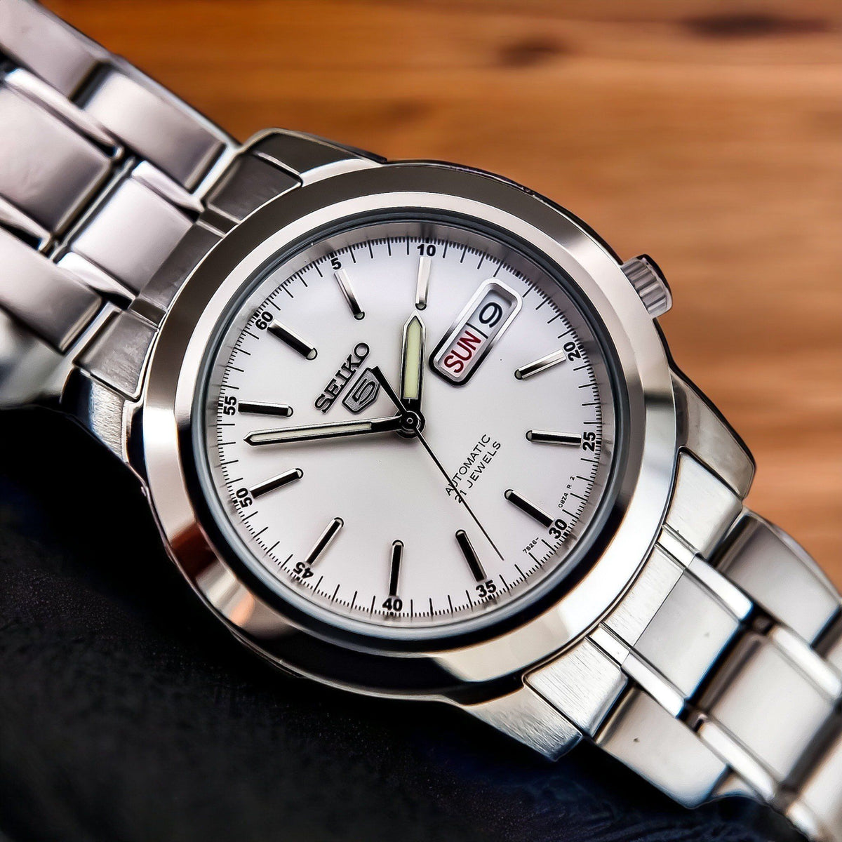 Seiko 5 Automatic SNKE49K1 macro view focusing on white dial face and steel hour markers