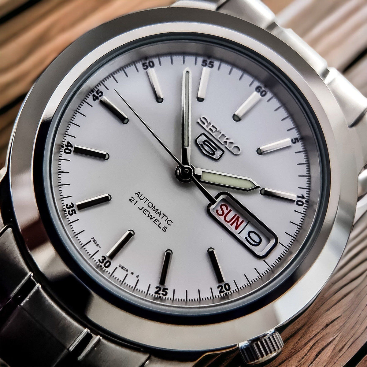 Seiko 5 Automatic SNKE49K1 detailed shot showing white dial indices and day-date display window