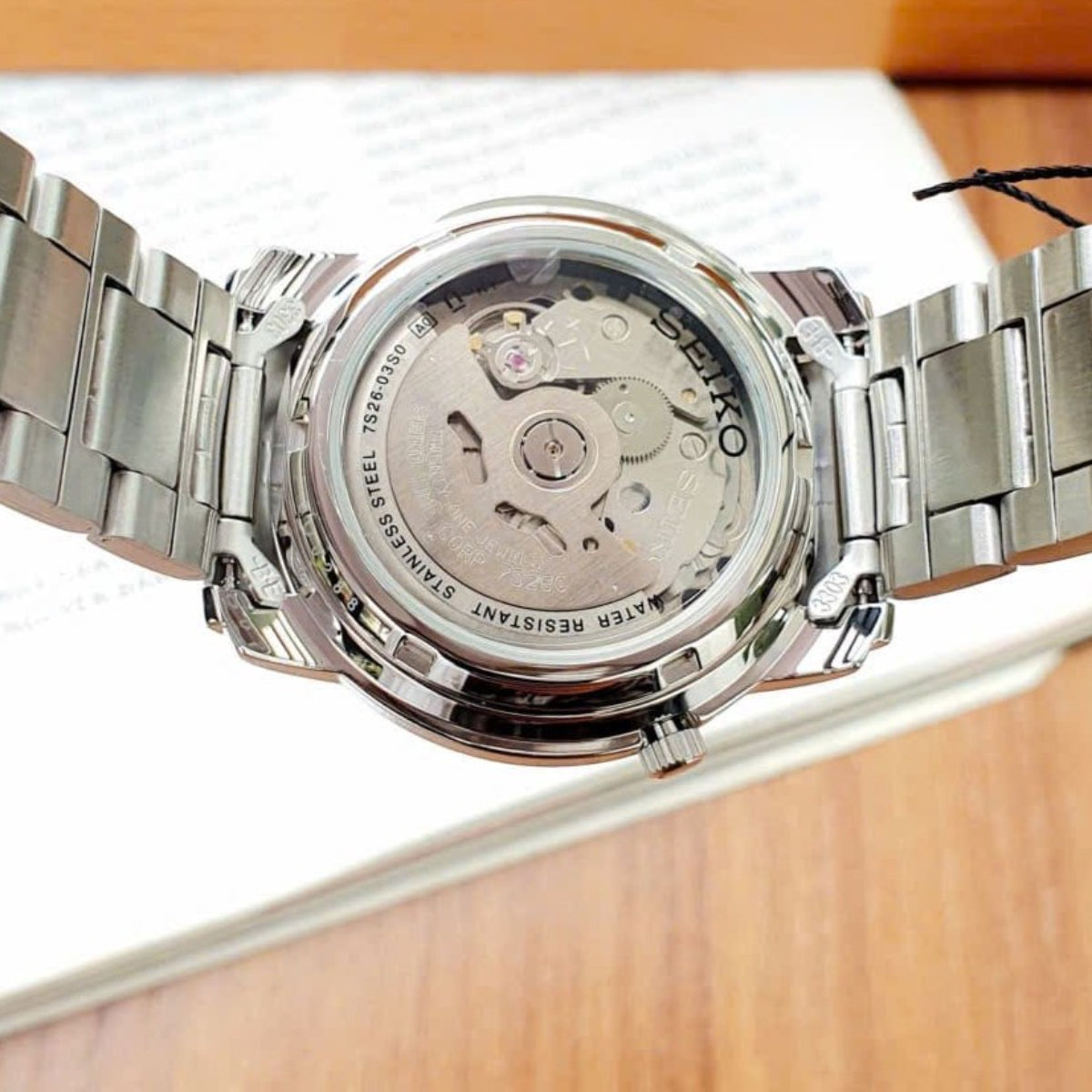 Seiko 5 Classic SNKK71K1 back view displaying exhibition case back, automatic movement, and steel bracelet