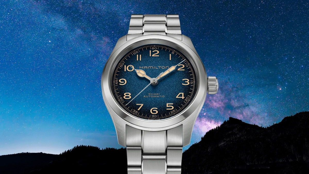 Hamilton Khaki Field Murph H70405140 38mm mens automatic watch front view showcasing blue dial against starry night sky background