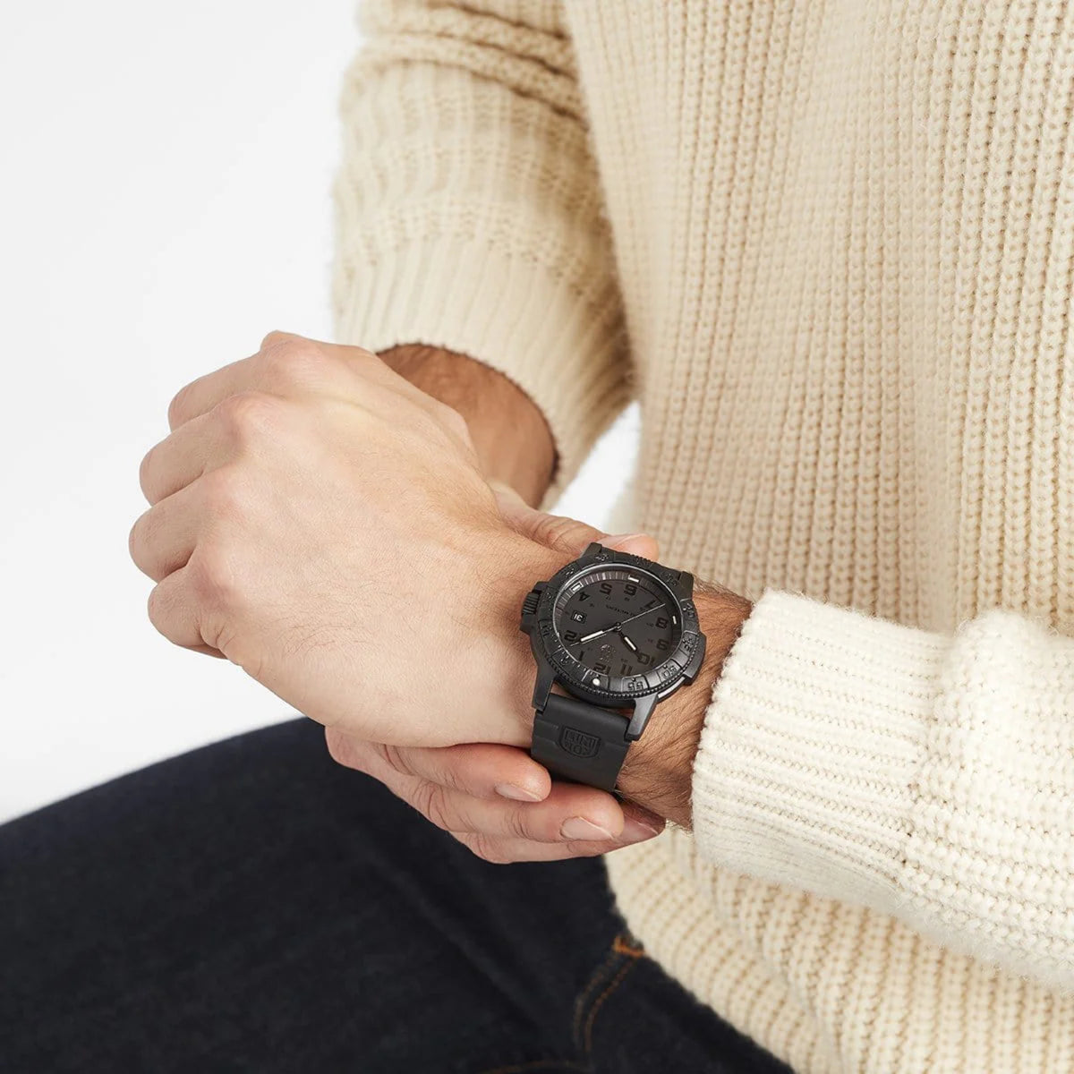Model wearing the stealthy Luminox Leatherback Sea Turtle XS.0321.BO.L wristwatch paired with a cream knitted sweater