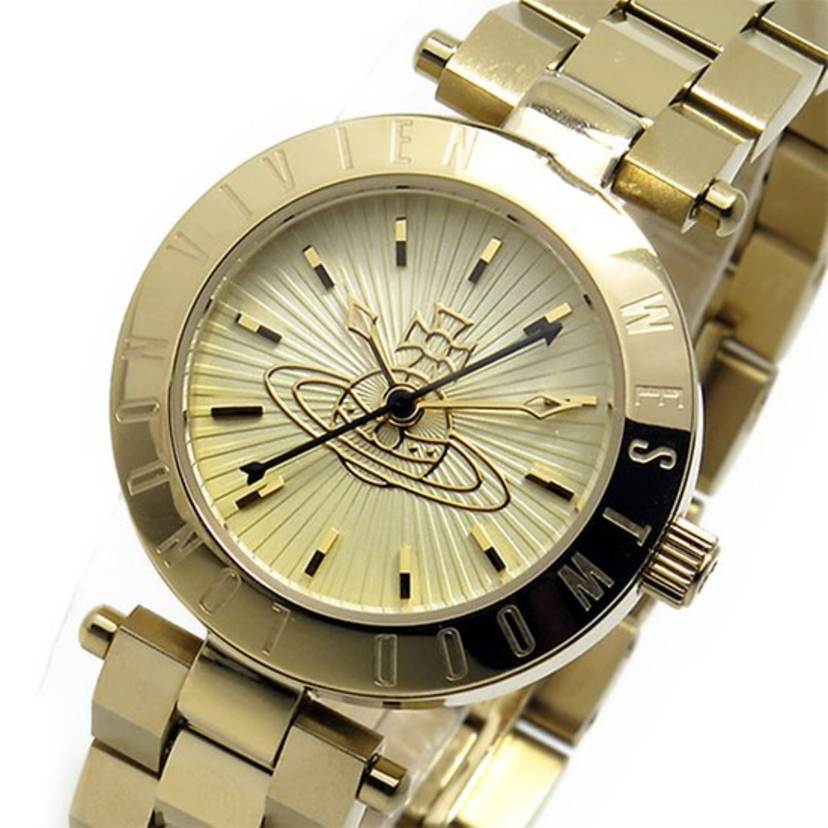Gold-tone watch face close-up with sunburst dial, orbit motif, and crown