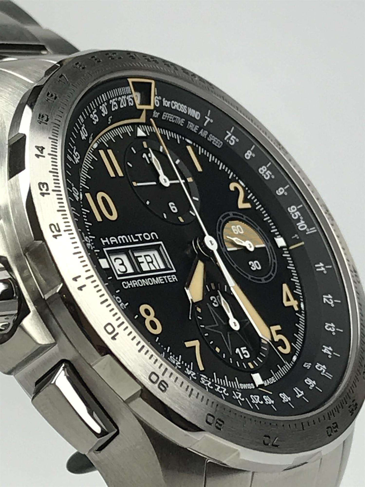 Men's steel chronograph watch side angle, black dial with gold accents and three subdials