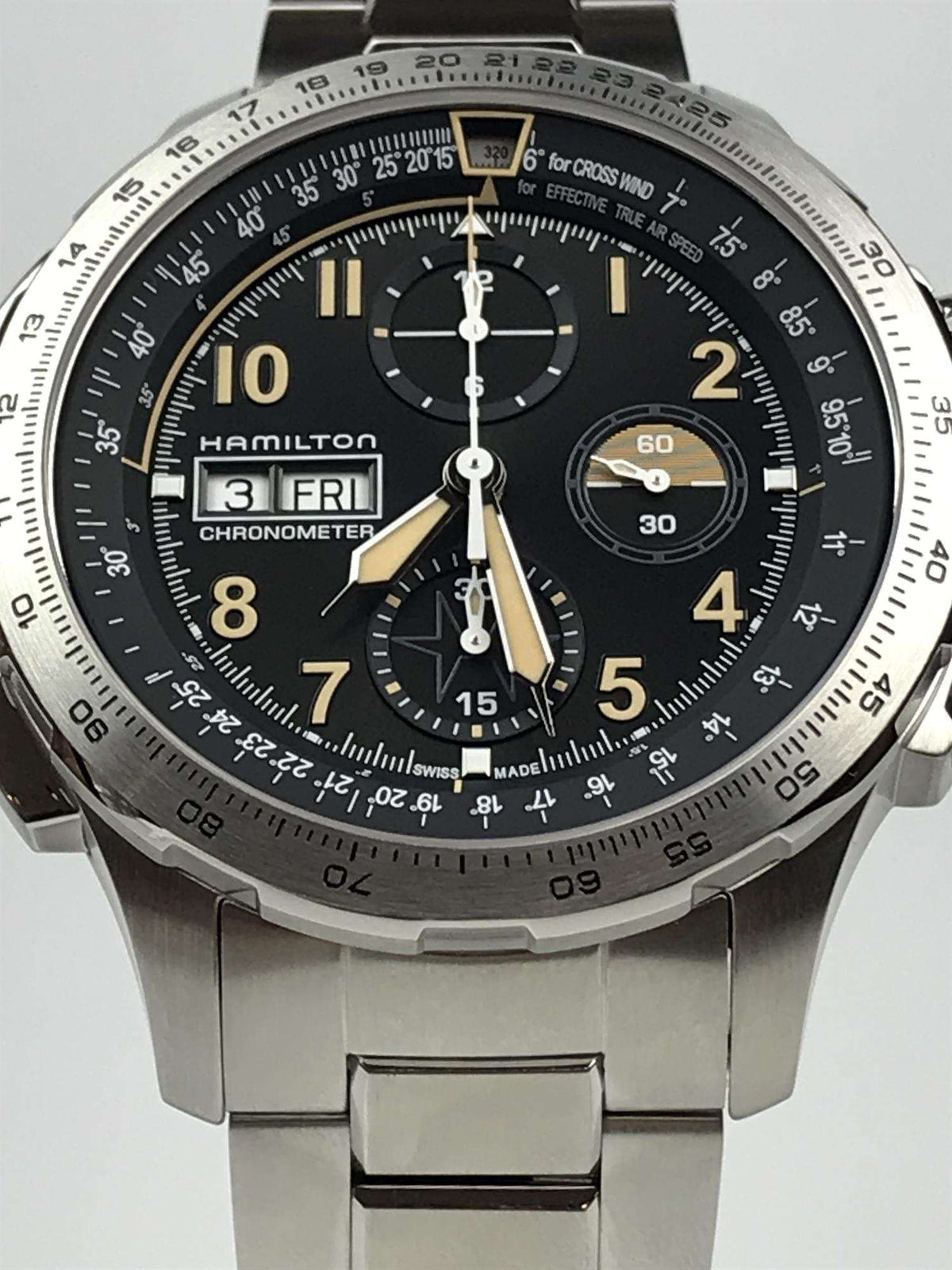 Men's steel chronograph watch front view, black dial with gold hands, three subdials