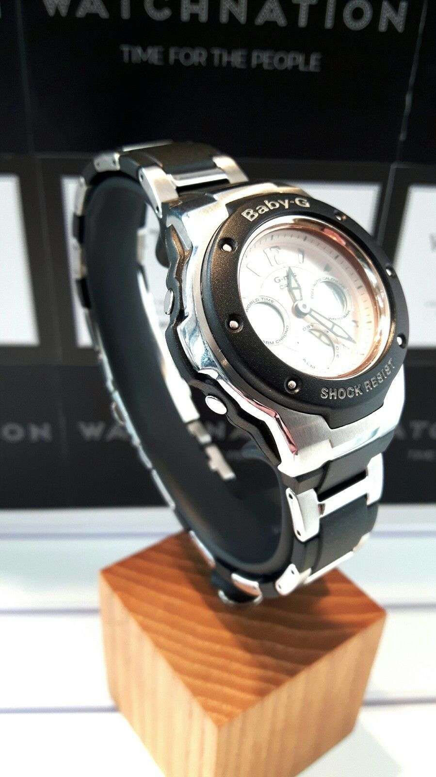 Baby-G women's wristwatch angled side view, black strap with silver case and bezel
