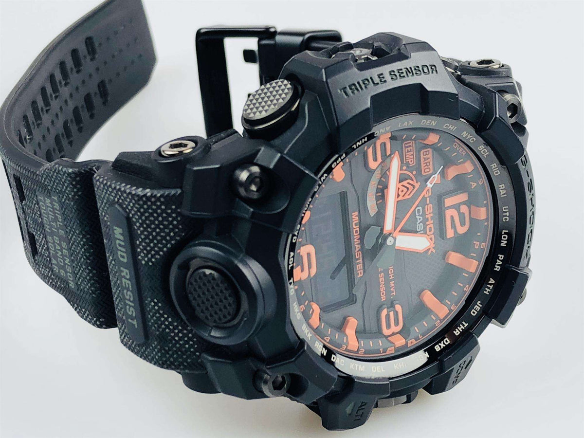 Black watch side view with textured strap and orange-accented triple-sensor dial