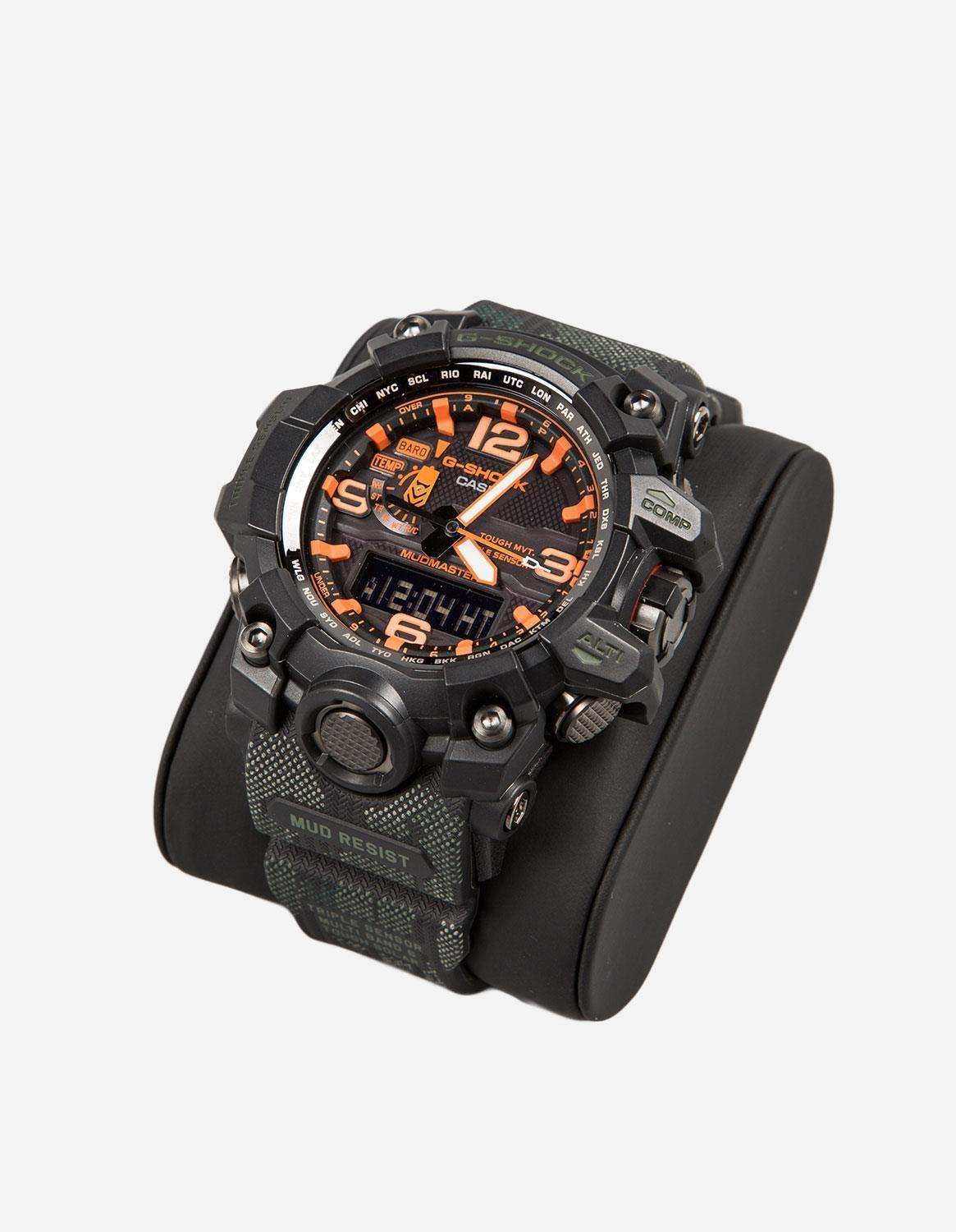 Black Mudmaster watch angled view with orange dial and textured strap