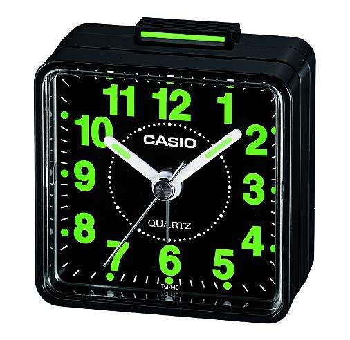 Black Casio analog alarm clock with green glowing numbers and green top display