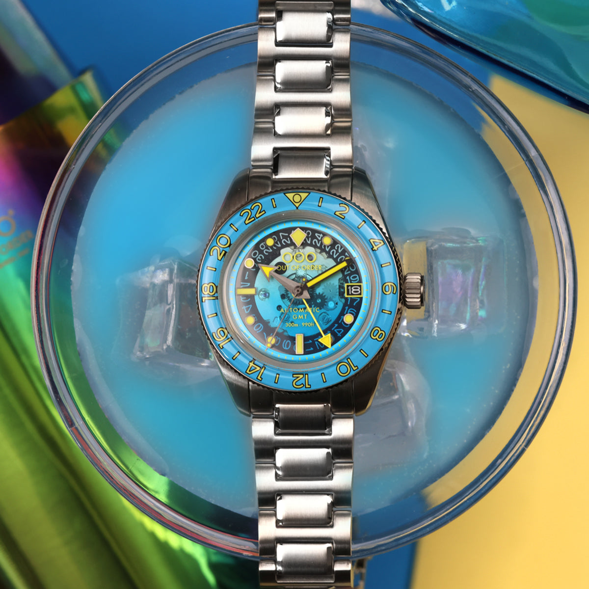 Men's automatic GMT watch, blue dial with yellow accents and steel bracelet, shown upright