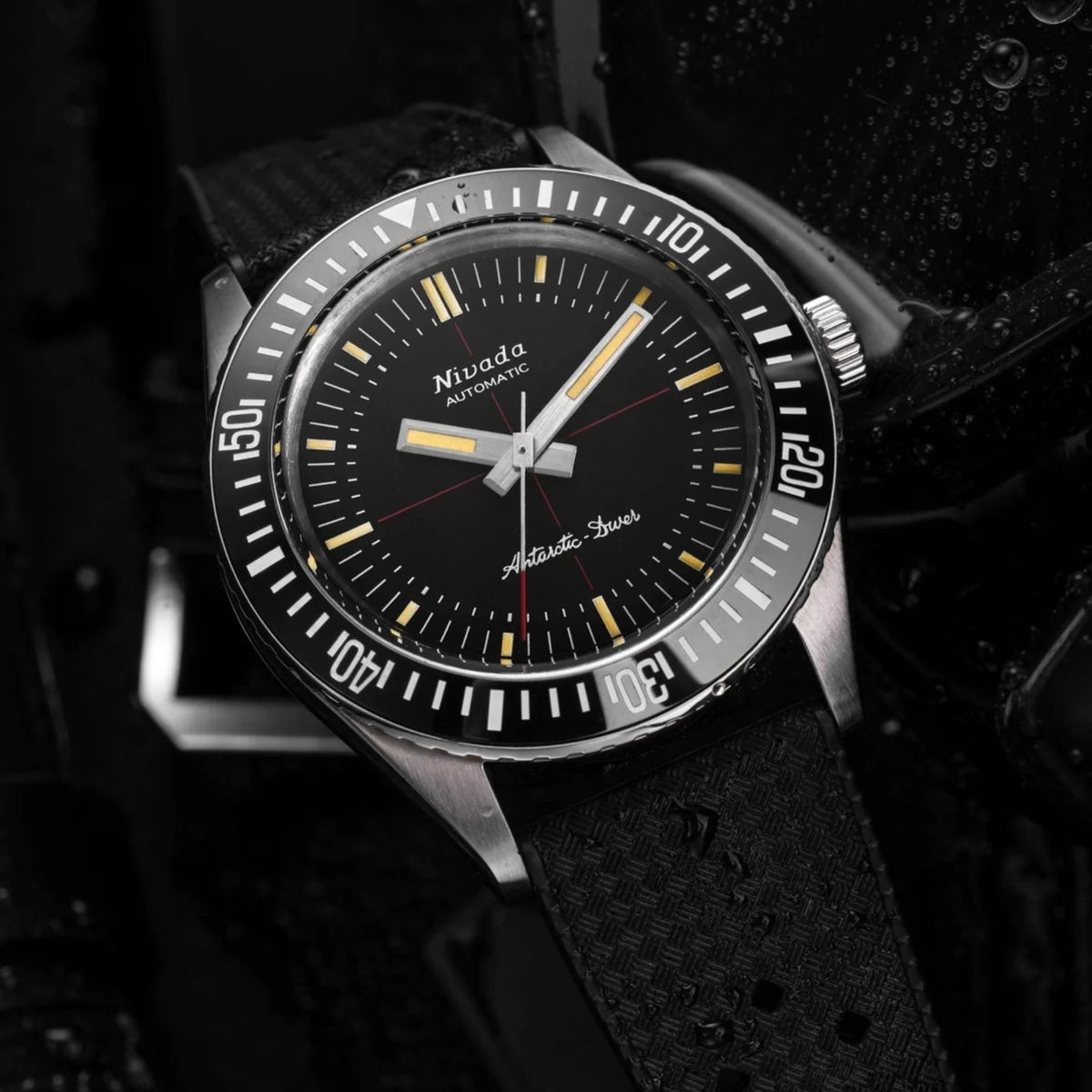 Black dial automatic diver watch with silver-toned case, baton indices, and red accents